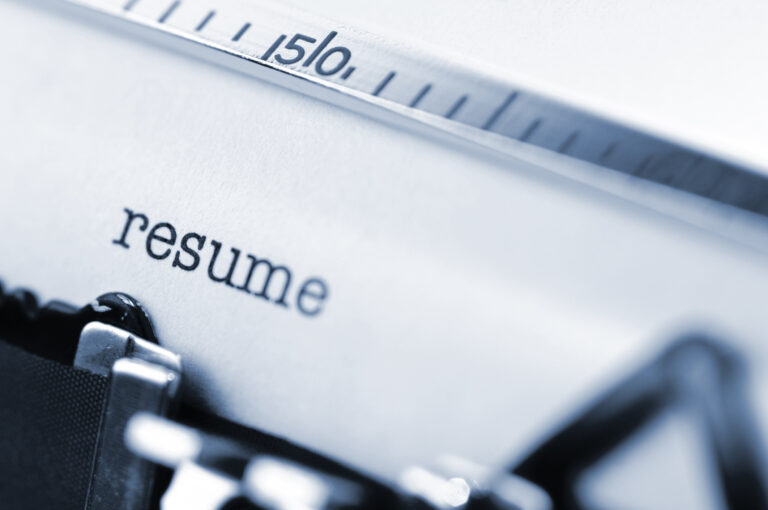 writing resume at typewriter