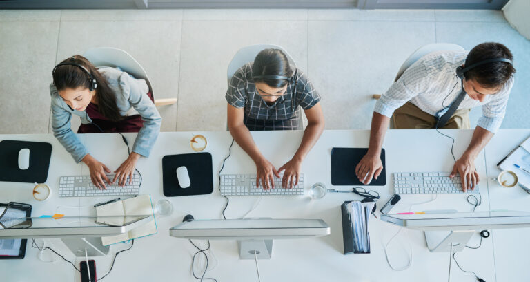 salespeople making calls at a desk