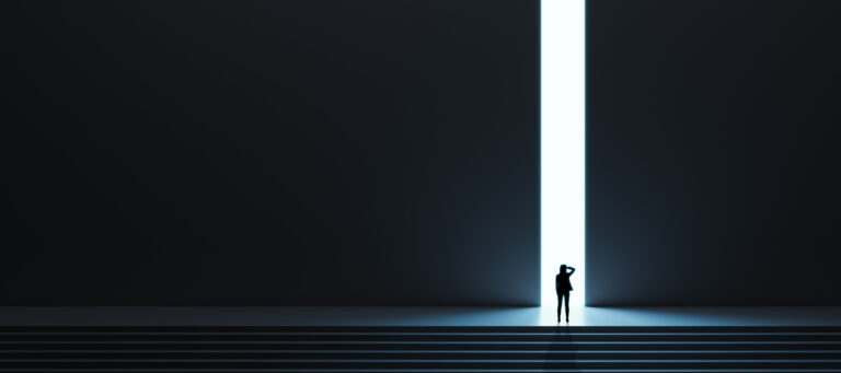 woman evaluating an opportunity standing at a door with bright light