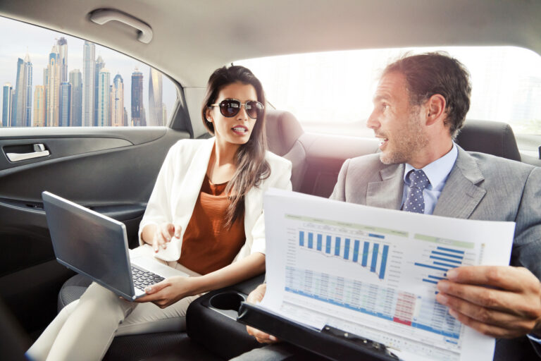 salespeople working in the car on the way to a meeting