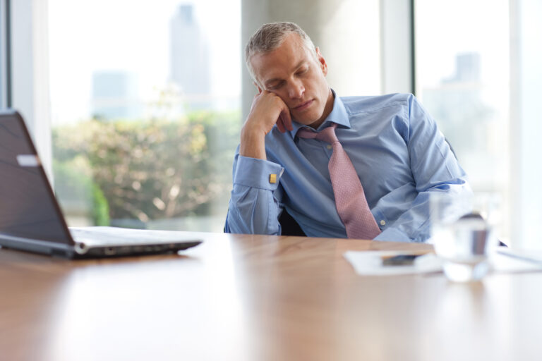 man falling asleep at desk