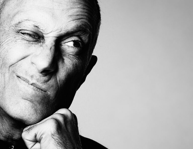 An older bald white man winking.