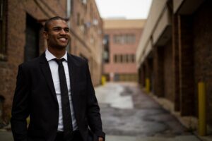 A man wearing a suit smiling.