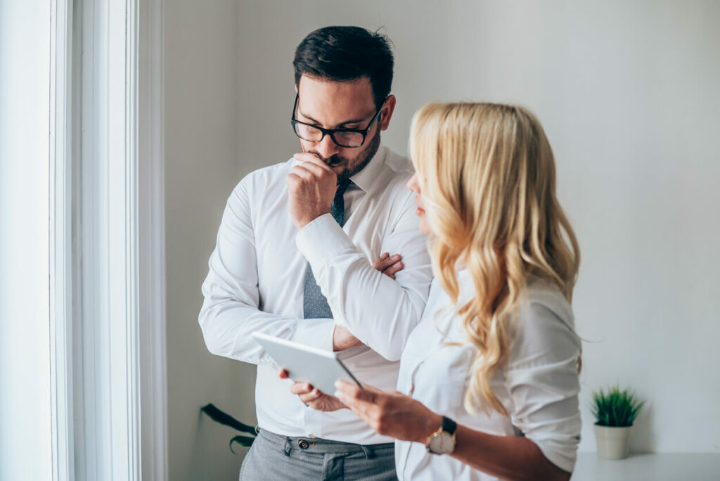 Business woman and business man interviewing sales talent.