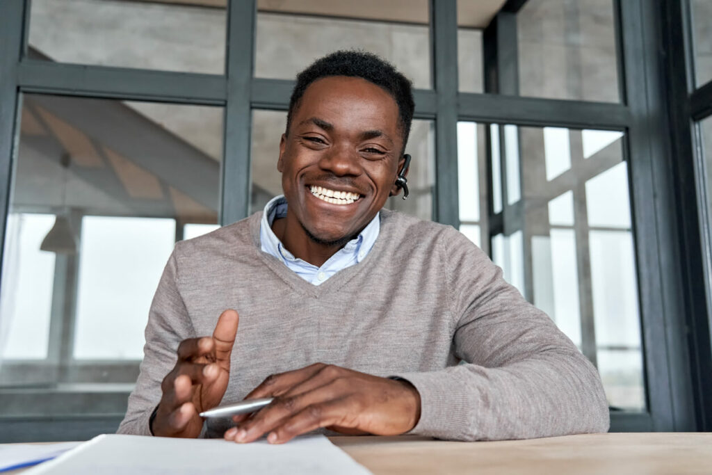 man smiling at desk