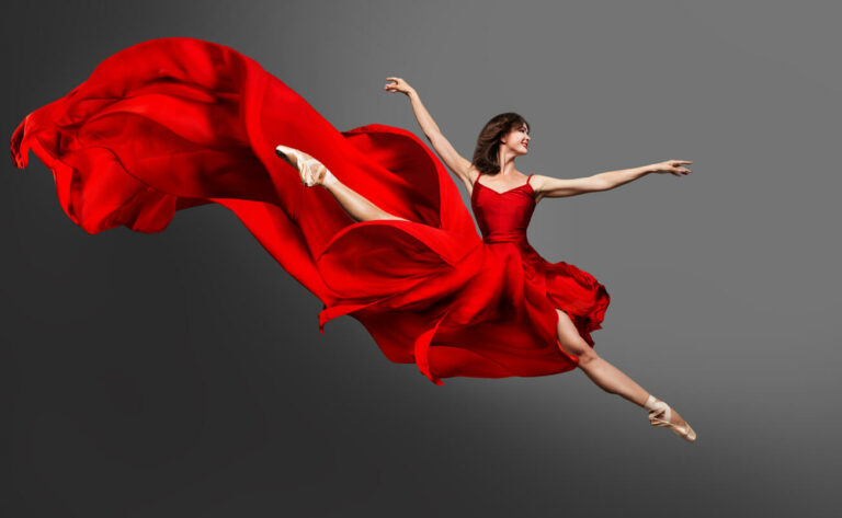 Ballerina leaping in red dress.