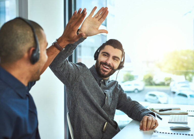 Two salespeople celebrating.