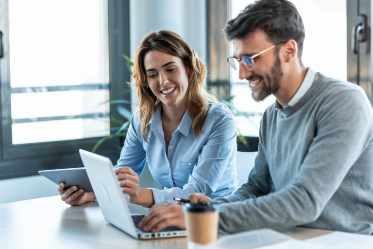two colleagues happy at work