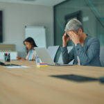 Sales professional reviewing job application results at a desk