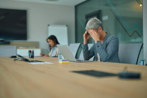 Sales professional reviewing job application results at a desk