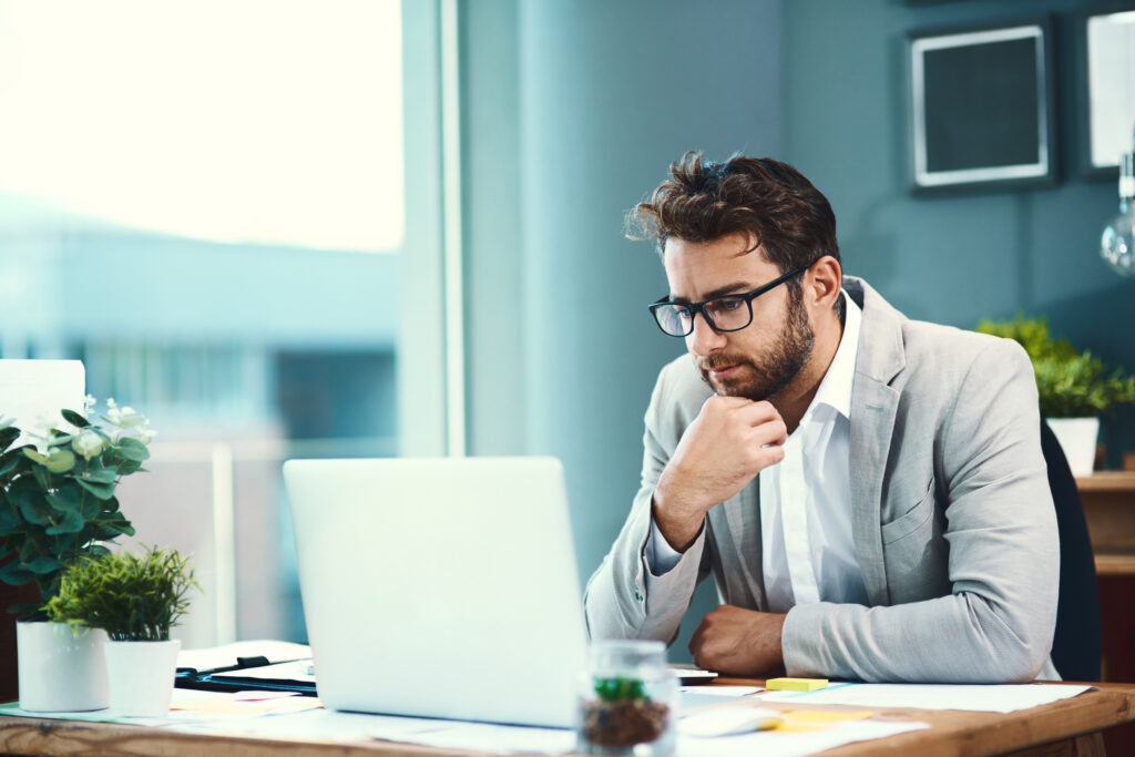 Professional sales representative reviewing a new logo opportunity on a laptop