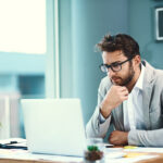 Professional sales representative reviewing a new logo opportunity on a laptop