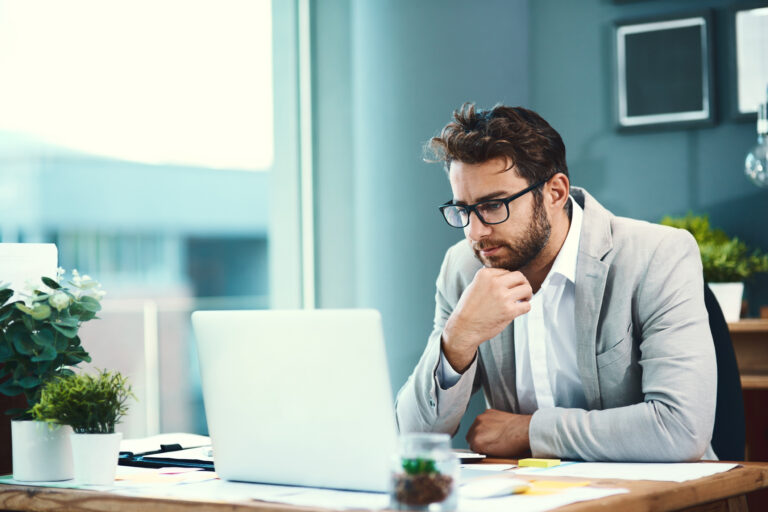 Professional sales representative reviewing a new logo opportunity on a laptop